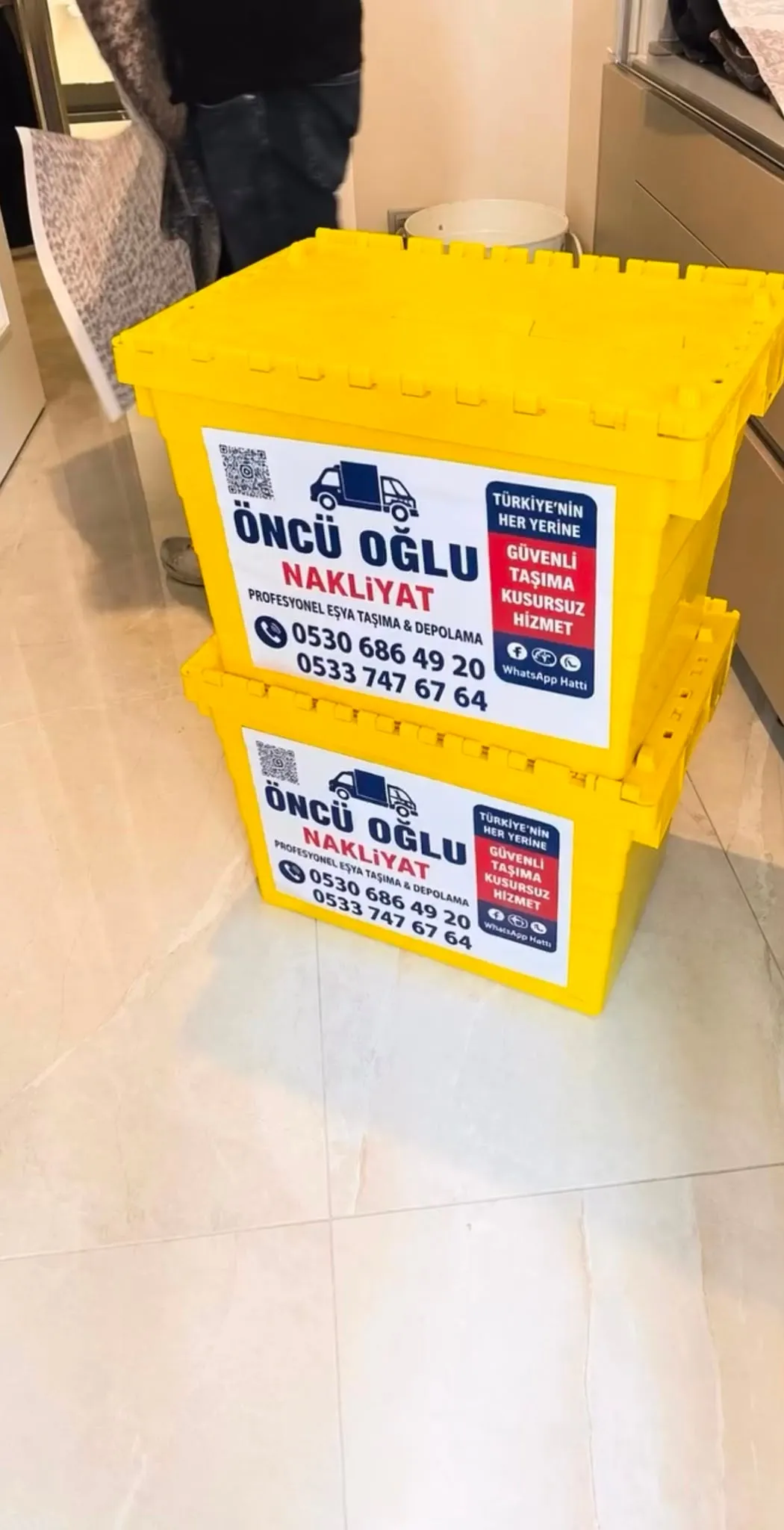 Öncü Oğlu Nakliyat etiketli sarı taşıma kasaları üst üste istiflenmiş